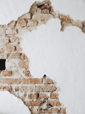 cracked-concrete-white-wall-with-bricks